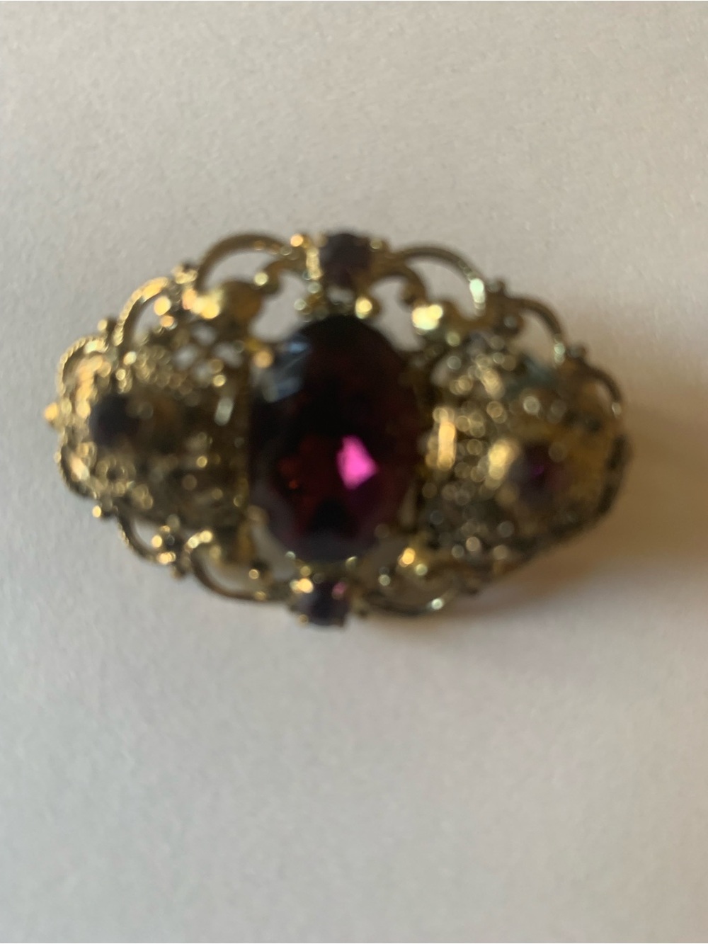 Vintage-Style Gold Filigree Brooch with Deep Purple Stone
